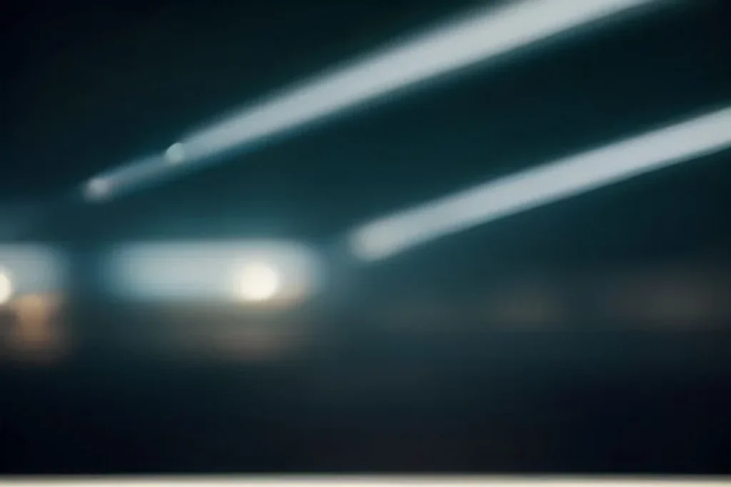 Smartphone with a blurred glowing screen on a table, stadium lights in bokeh behind