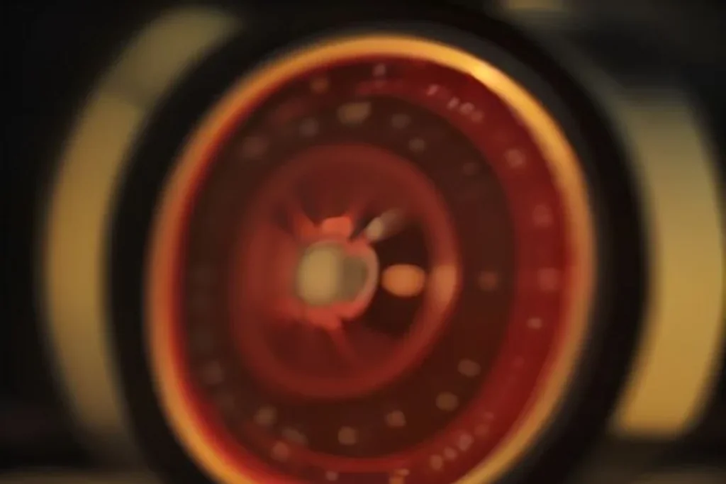Roulette wheel captured in soft motion blur with warm bokeh lights, no readable numbers